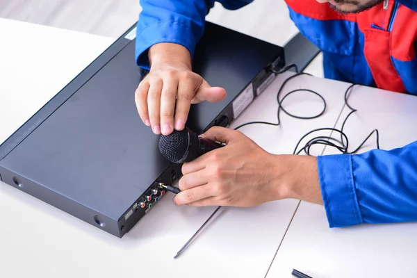 Man repairman repairing dvd player at service center