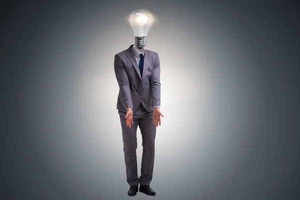 Businessman in bright idea concept with lightbulb head — Stock Photo, Image