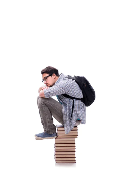 Jeune étudiant assis sur le dessus de la pile de livres sur blanc — Photo