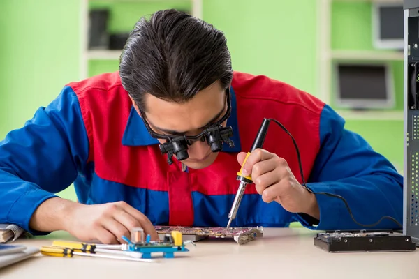 Computer engineer repairing broken desktop