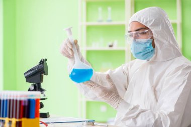 Laboratuvarda yeni bir deney üzerinde çalışan kimyager.