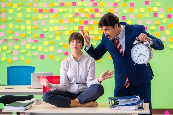 Man en vrouw in het kantoor met veel tegenstrijdige prioriteiten in — Stockfoto