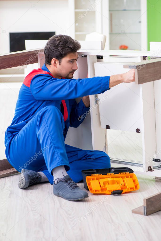 Repair contractor repairing broken furniture at home