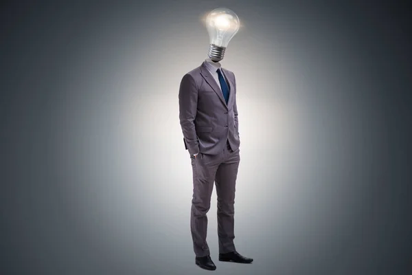 Businessman in bright idea concept with lightbulb head — Stock Photo, Image