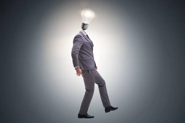 Businessman in bright idea concept with lightbulb head — Stock Photo, Image