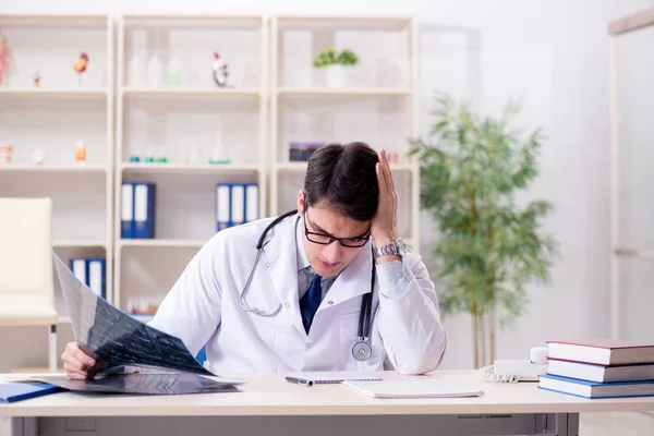 Jovem médico sentado no escritório — Fotografia de Stock