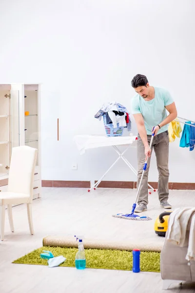 Young attractive man husband doing mopping at home — Stock Photo, Image