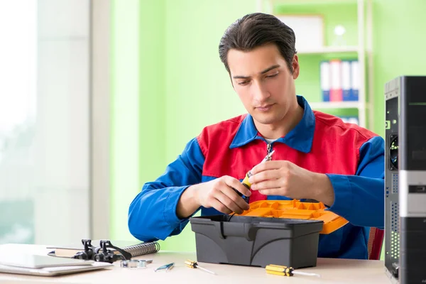 Computer engineer repairing broken desktop