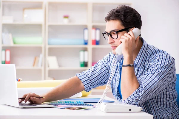 Young designer working on new project and choosing colours — Stock Photo, Image