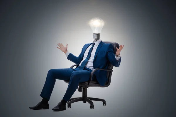 Businessman in bright idea concept with lightbulb head — Stock Photo, Image