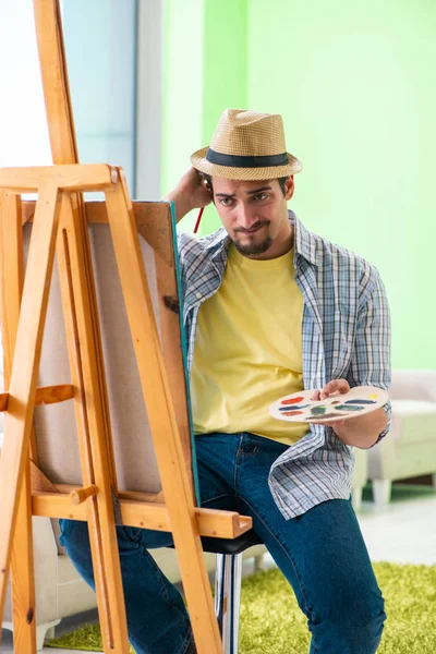 Young male artist working on new painting in his studio — Stock Photo, Image