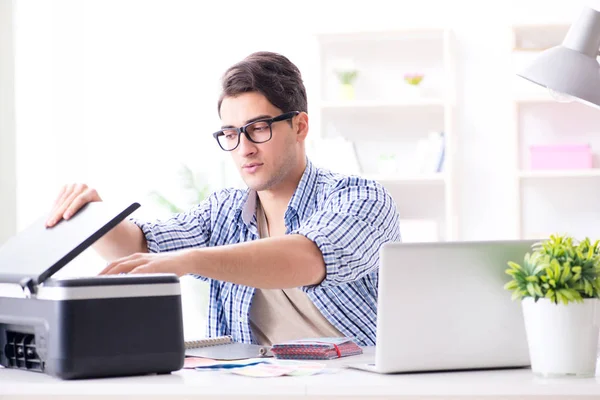 Giovane dipendente che lavora alla fotocopiatrice in ufficio — Foto Stock