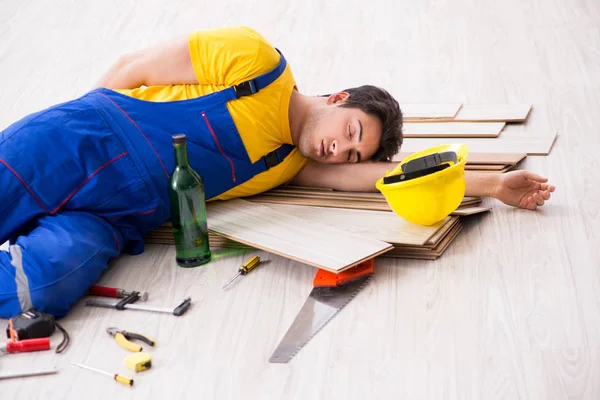 休憩中に酒を飲む床の修理人 — ストック写真