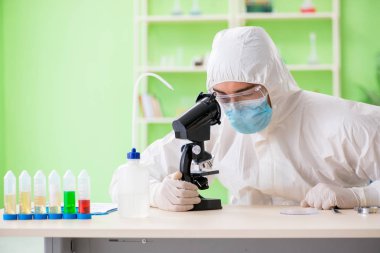 Laboratuvarda yeni bir deney üzerinde çalışan kimyager.