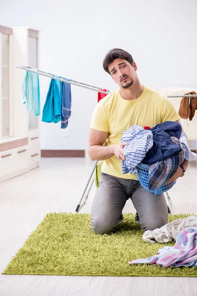 Handsome man husband doing laundering at home — Stock Photo, Image