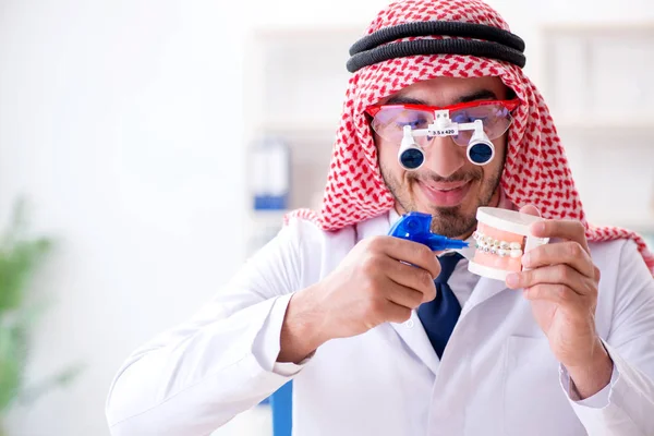 Arab dentist working on new teeth implant — Stock Photo, Image