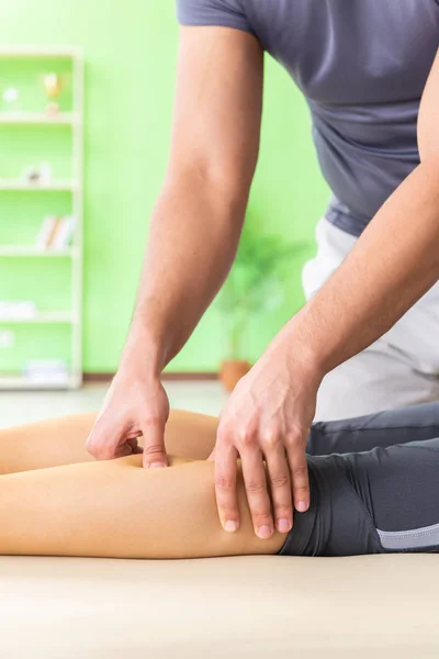 Young doctor chiropractor massaging patient — Stock Photo, Image