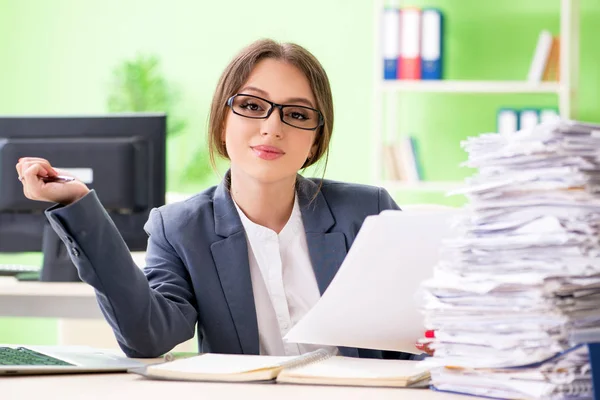 Ung kvinnlig anställd mycket upptagen med löpande pappersarbete — Stockfoto