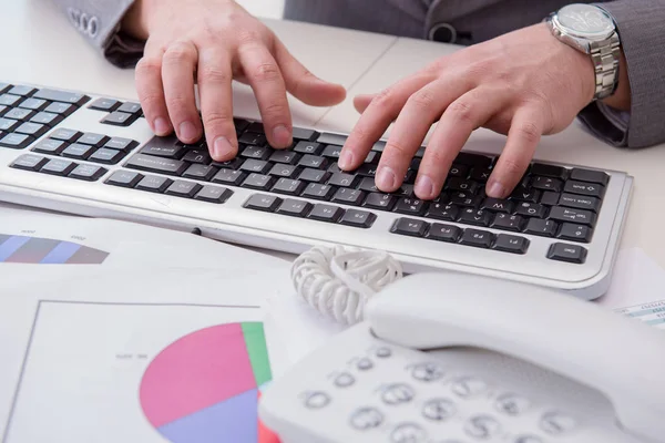 Finance professional working on keyboard with reports — Stock Photo, Image