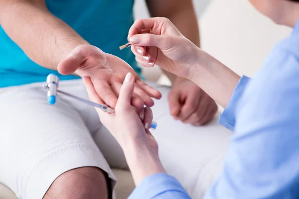 Arzt überprüft Nervenreflexe mit Hammer — Stockfoto