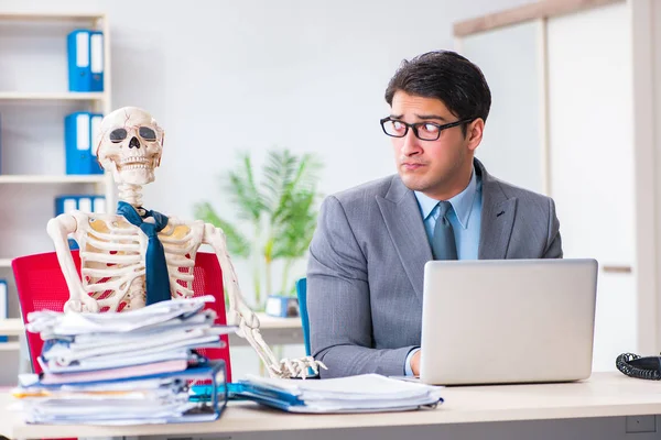 Businessman working with skeleton in office — Stock Photo, Image