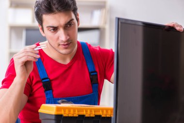 Profesyonel tamir mühendisi bozuk televizyonu tamir ediyor.