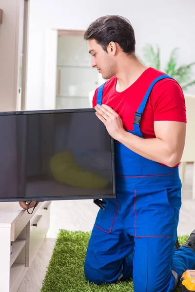Profesyonel tamir mühendisi bozuk televizyonu tamir ediyor.