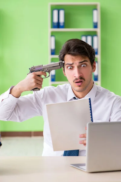 Despaired businessman thinking of suicide in the office — Stock Photo, Image