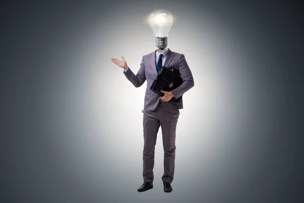 Businessman in bright idea concept with lightbulb head — Stock Photo, Image