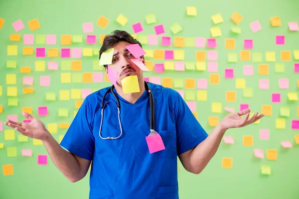 Young doctor with many reminders and urgent work — Stock Photo, Image