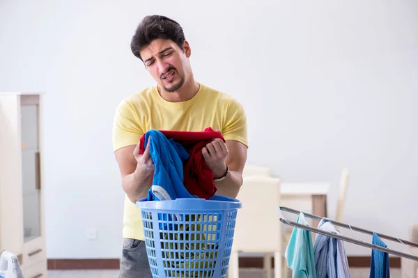 Handsome man husband doing laundering at home — Stock Photo, Image