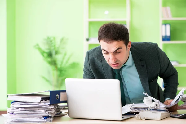 Uomo d'affari arrabbiato per il lavoro eccessivo seduto in ufficio — Foto Stock
