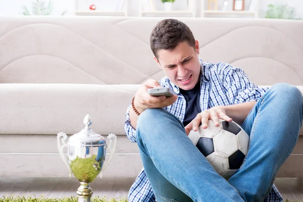 Young man student watching football at home — Stock Photo, Image