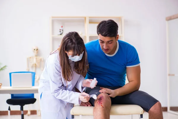 Médico visitante del paciente después de sufrir lesiones deportivas — Foto de Stock