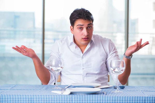 Handsome man alone in restaraunt on date