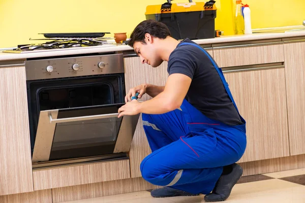 Jovem empreiteiro de serviços montagem de mobiliário de cozinha — Fotografia de Stock