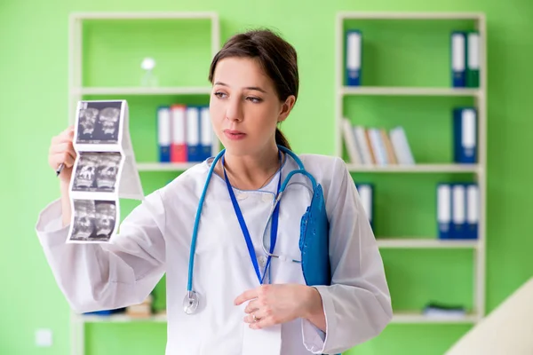 Female doctor gynecologyst writing medical record in the clinic — Stock Photo, Image