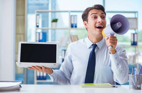 Businessman with loudspeaker presenting at his laptop — Stock Photo, Image
