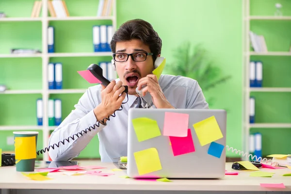 Young help desk operator working in office with many conflicting