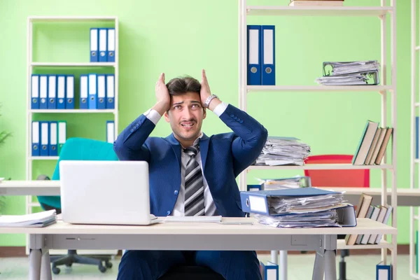 Empresario descontento con el trabajo excesivo sentado en la oficina — Foto de Stock