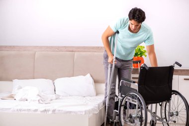 Genç yakışıklı engelli adam evde iyileşiyor. 