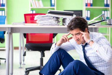 Frustrated businessman stressed from excessive work clipart