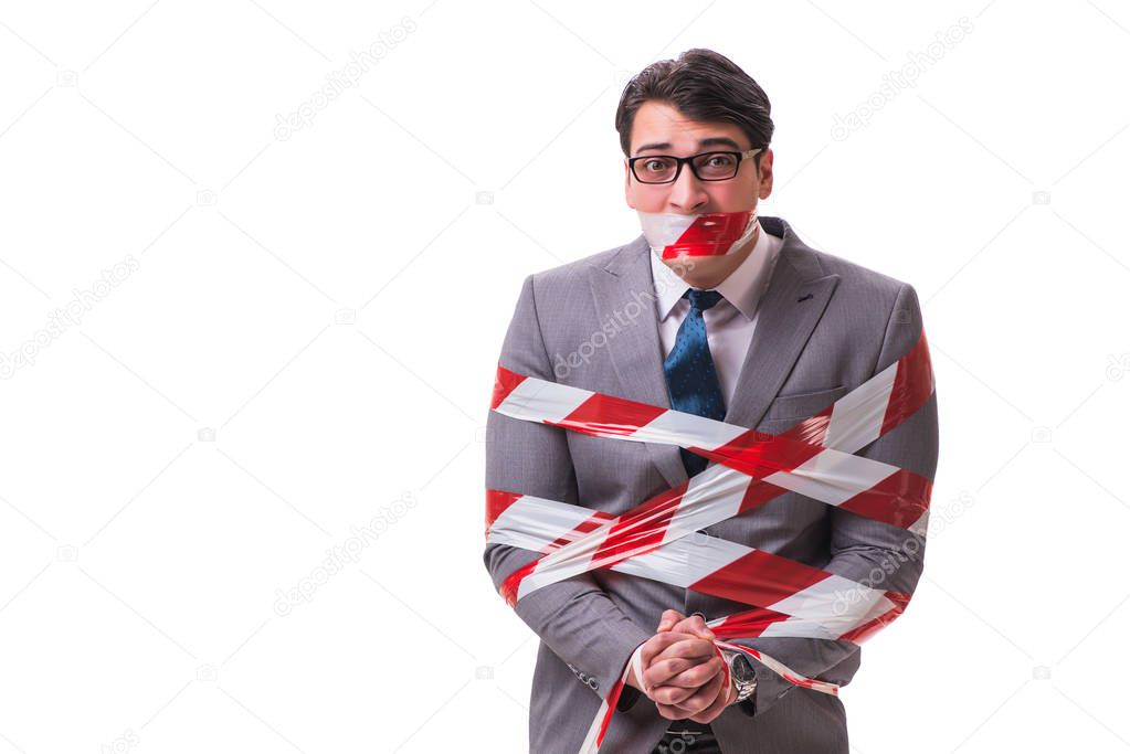 Businessman tied by tape isolated on white