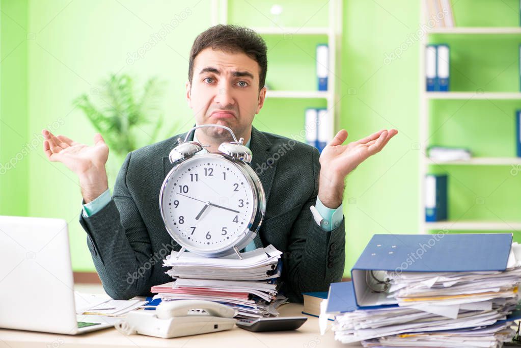 Businessman angry with excessive work sitting in the office in t