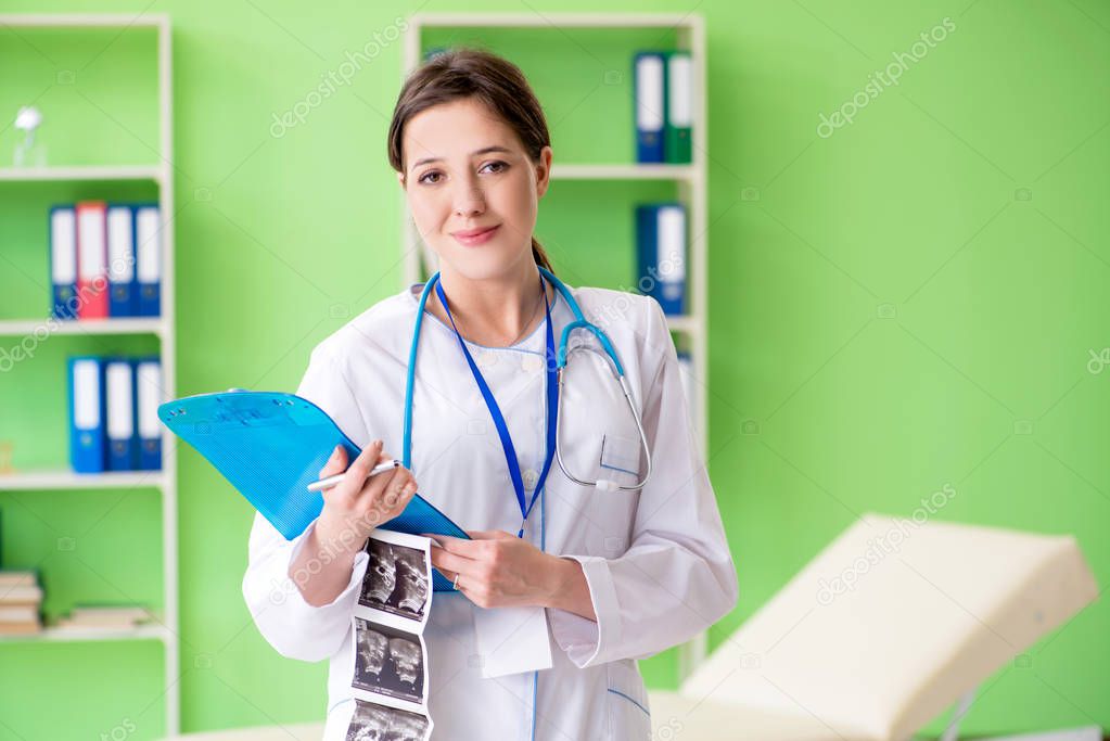 Female doctor gynecologyst writing medical record in the clinic