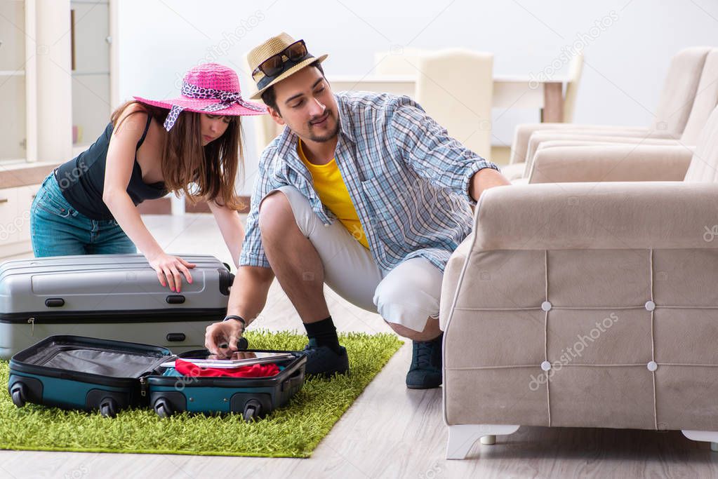 Young family packing for vacation travel