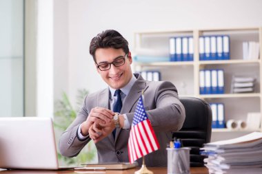 Ofisinde Amerikan bayrağı taşıyan bir iş adamı