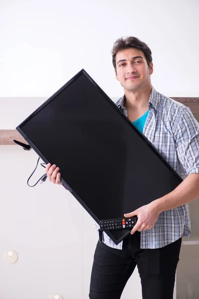 Man trying to fix broken tv