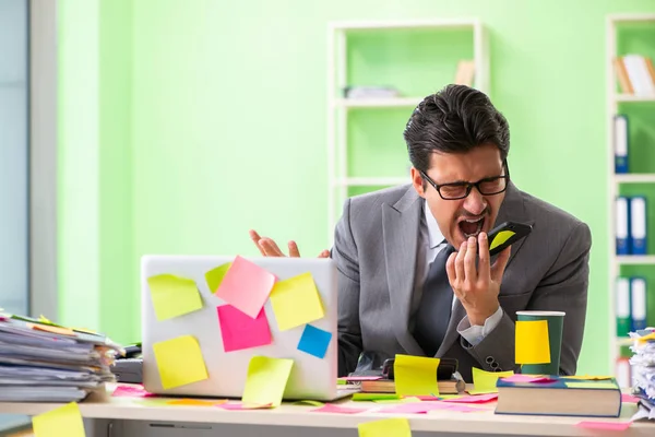 Businessman unhappy with many conflicting priorities sitting in — Stock Photo, Image