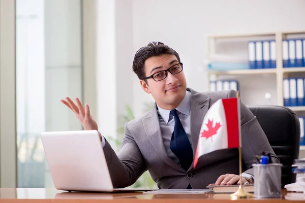 stock image Businessman with Canadian flag in office